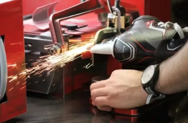 Ski equipment lies on untouched snow, surrounded by majestic mountains under a clear sky.